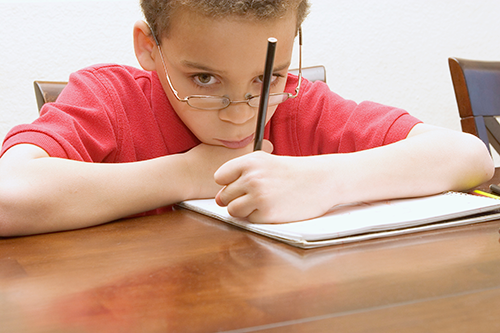 Young boy reluctant to do homework
